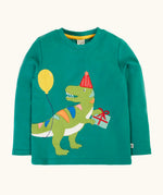 Frugi organic cotton adventure long sleeve hut green child's top with t-rex dinosaur wearing a party hat carrying a present with a yellow balloon appliques on the front.