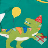 Close up of the green t-rex dinosaur wearing a red party hat applique on the Frugi organic cotton adventure long sleeve hut green child's top.