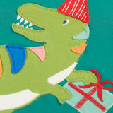 Close up of the green t-rex dinosaur applique on the Frugi organic cotton adventure long sleeve hut green child's top.