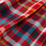 Close up of skirt of the Frugi organic cotton agnes festive check children's long sleeved dress.