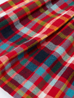 Close up of skirt of the Frugi organic cotton agnes festive check children's long sleeved dress.