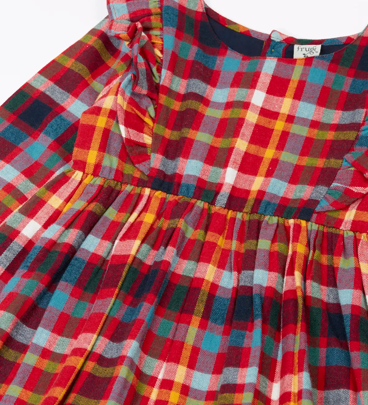 Close up of the shoulder frills on Frugi organic cotton agnes festive check children's long sleeved dress.