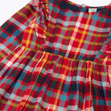 Close up of the shoulder frills on Frugi organic cotton agnes festive check children's long sleeved dress.