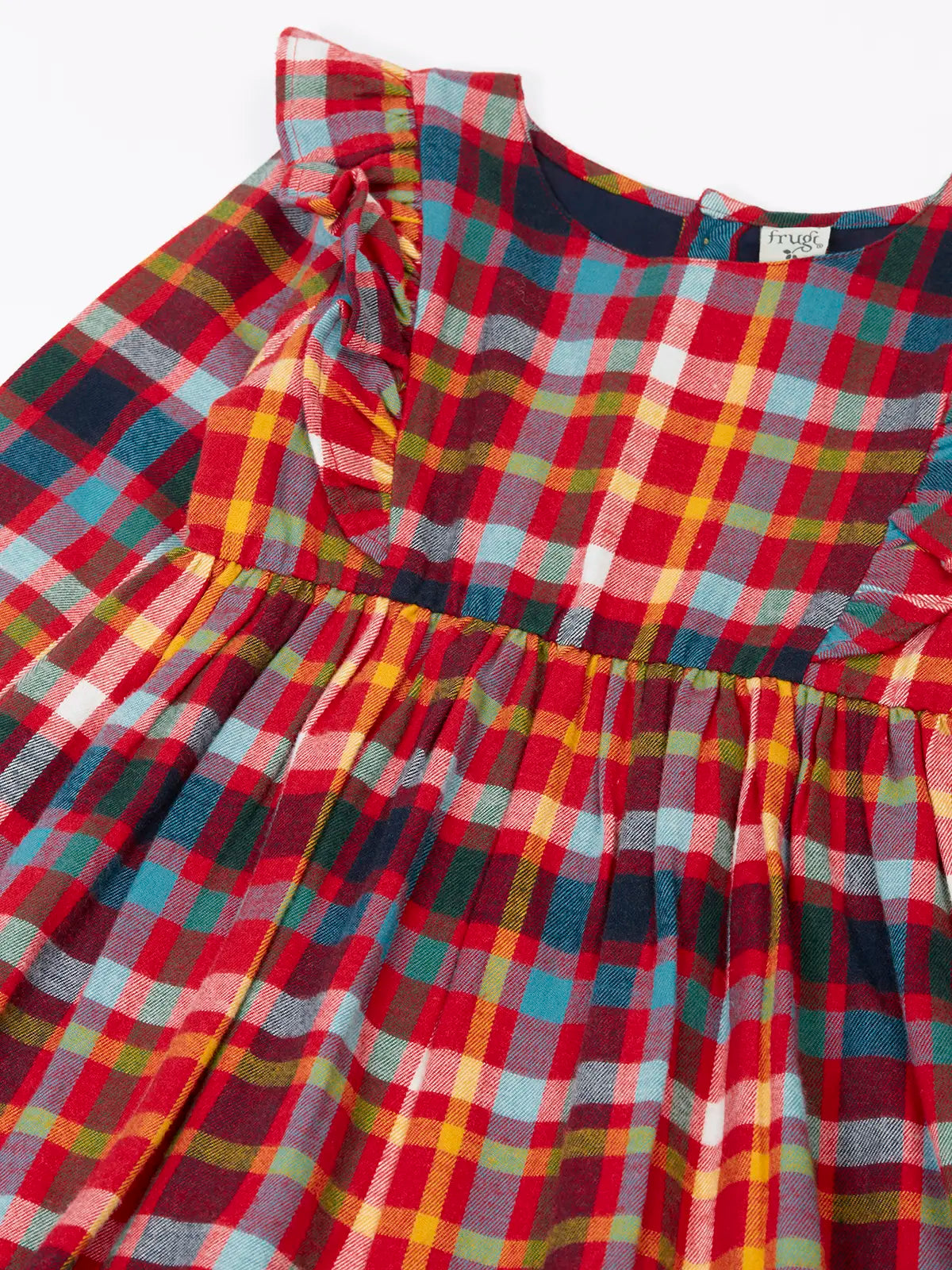 Close up of the shoulder frills on Frugi organic cotton agnes festive check children's long sleeved dress.