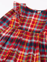 Close up of the shoulder frills on Frugi organic cotton agnes festive check children's long sleeved dress.