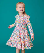 Child wearing the Frugi organic cotton annika skater dress with floral flight print and frilled shoulders. All over print featuring pegasus, flowers and foliage. 