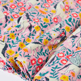 Close up of the front of the Frugi organic cotton annika skater dress with floral flight print and frilled shoulders. All over print featuring pegasus, flowers and foliage. 