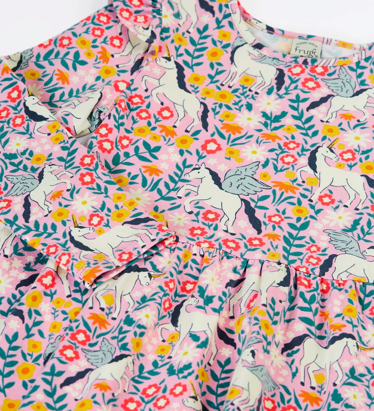Close up of the front of the Frugi organic cotton annika skater dress with floral flight print showing the filled shoulders.