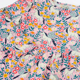 Close up of the front of the Frugi organic cotton annika skater dress with floral flight print showing the filled shoulders.
