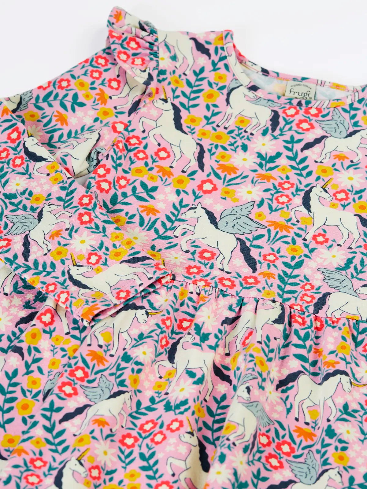 Close up of the front of the Frugi organic cotton annika skater dress with floral flight print showing the filled shoulders.