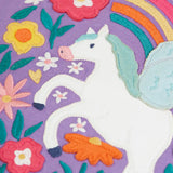 Pegasus applique with a rainbow and flowers applique on the front of the Frugi organic cotton bethany long sleeved periwinkle purple top.