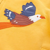 Close up of the eagle applique on the Frugi organic cotton blaire zip hoodie in bumblebee yellow. 