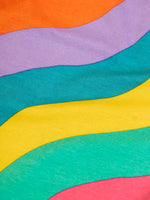 Close up of the rainbow ric rac tripes on the Frugi organic cotton bryher long sleeve top.