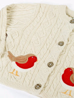 Close up of the Frugi organic cotton natural cream cable knit baby cardigan with robin appliques.