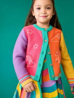 Child wearing the Frugi organic cotton cammie cardigan with a hotchpotch unicorn design. white star, clouds and unicorn outlines details on the front. 