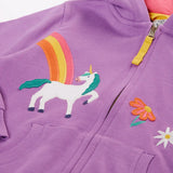 Close up of unicorn, rainbow and flower appliues on teh front of the Frugi organic cotton purple periwinkle carbis zipped children's hoodie.