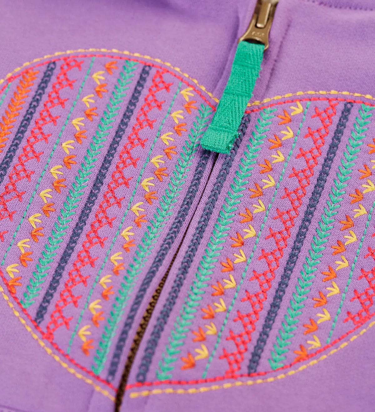 Close up of the multicoloured embroidered heart design on the front of the Frugi organic cotton purple periwinkle carbis zipped children's hoodie. 