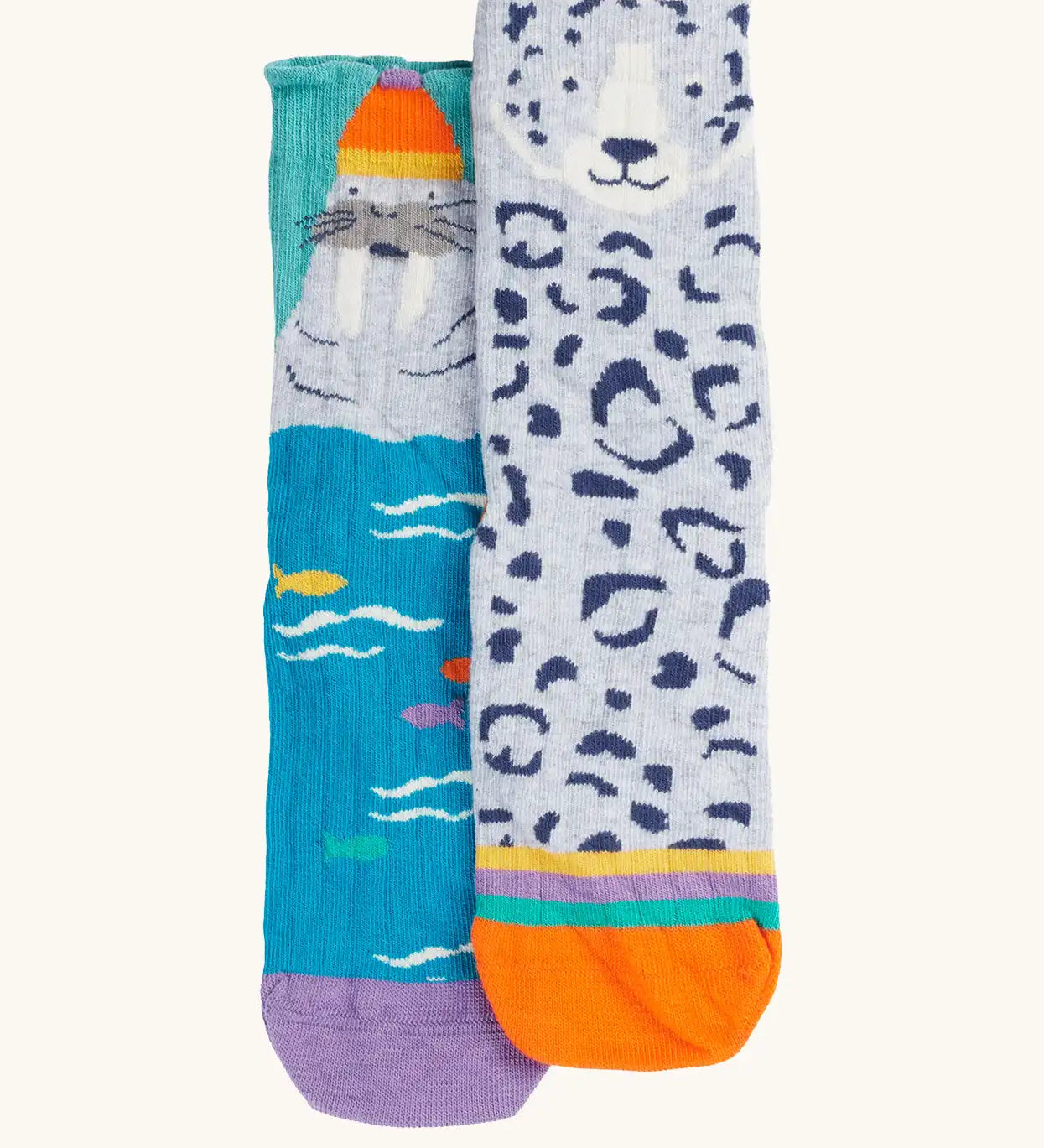Frugi organic cotton character socks 2 pack. One blue pair with a walrus wearing a bobble hat, one pair with a grey leopard.