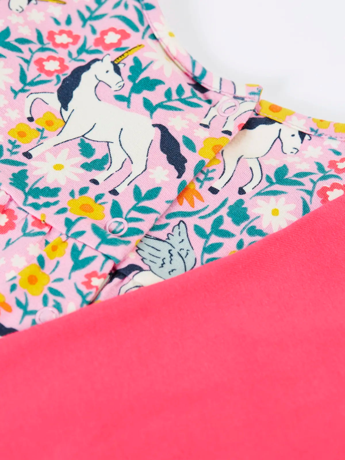 Close up of the popper closure on the back of the top from the Frugi organic cotton Charlotte outfit.