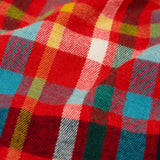 Close up of the multi coloured check material trousers from the Frugi organic cotton caden check festive fox pyjamas.