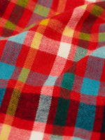 Close up of the multi coloured check material trousers from the Frugi organic cotton caden check festive fox pyjamas.