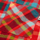Close up of the chest pocket on the Frugi organic cotton festive check hector long sleeve shirt.