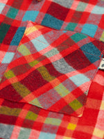 Close up of the chest pocket on the Frugi organic cotton festive check hector long sleeve shirt.