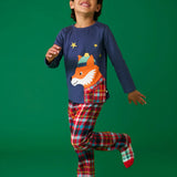 Child wearing the Frugi organic cotton caden check festive fox pyjamas. Long sleeved navy top with fox applique with multi coloured check trousers. 