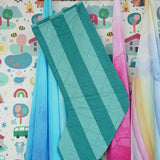 Back of the Frugi organic cotton Christmas stocking. Striped teal quilted style stocking hung up on a wooden shelf in the Babipur playroom.