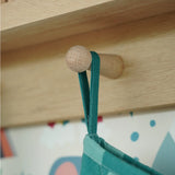 Close up of the hanging loop on the Frugi organic cotton Christmas stocking. Striped teal quilted style stocking with a robin wreath embroidery detail on teh front.