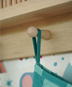 Close up of the hanging loop on the Frugi organic cotton Christmas stocking. Striped teal quilted style stocking with a robin wreath embroidery detail on teh front.