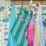 Frugi organic cotton Christmas stocking. Striped teal quilted style stocking with a robin wreath embroidery detail and hanging loop hung up in the Babipur playroom with a Senger rabbit soft toy inside.