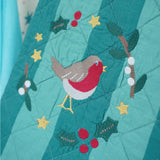Frugi organic cotton Christmas stocking. Close up of the robin wreath embroidery detail on the front.