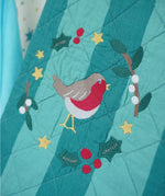 Frugi organic cotton Christmas stocking. Close up of the robin wreath embroidery detail on the front.