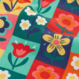 Close up of the rectangle flower stamps on the Frugi organic cotton ethel flared dungarees.