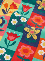 Close up of the rectangle flower stamps on the Frugi organic cotton ethel flared dungarees.