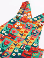 Close up of the metal clasps on the Frugi organic cotton ethel flared dungarees with rectangle flower stamps design.