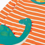 Close up of the teal nessie on the Frugi organic cotton felix long sleeve orange breton stripe top.