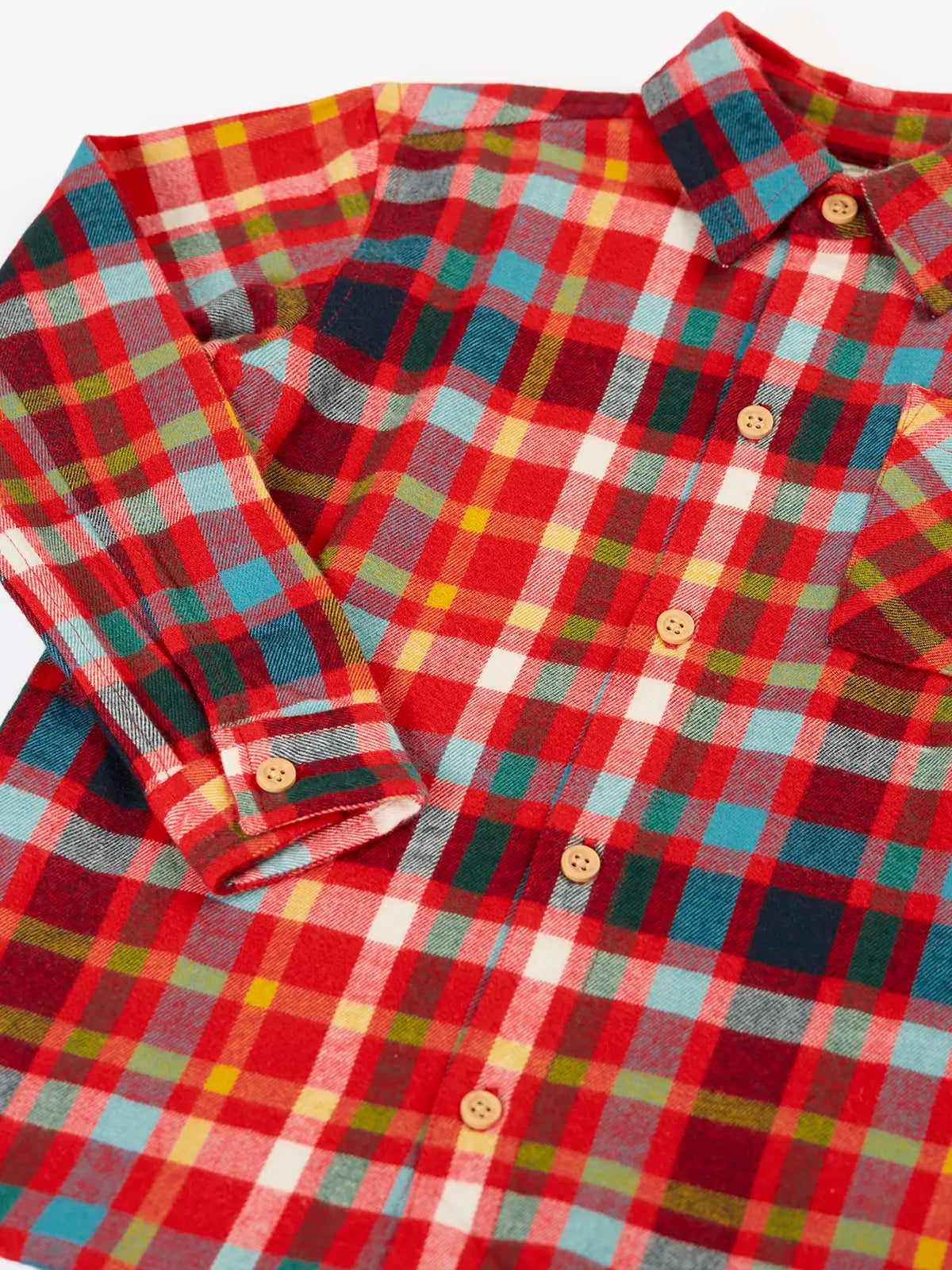Close up of the Frugi organic cotton festive check hector shirt with chest pocket.
