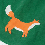 Close up of the fox applique on the hemline of the Frugi organic cotton peony holly green corduroy dress.