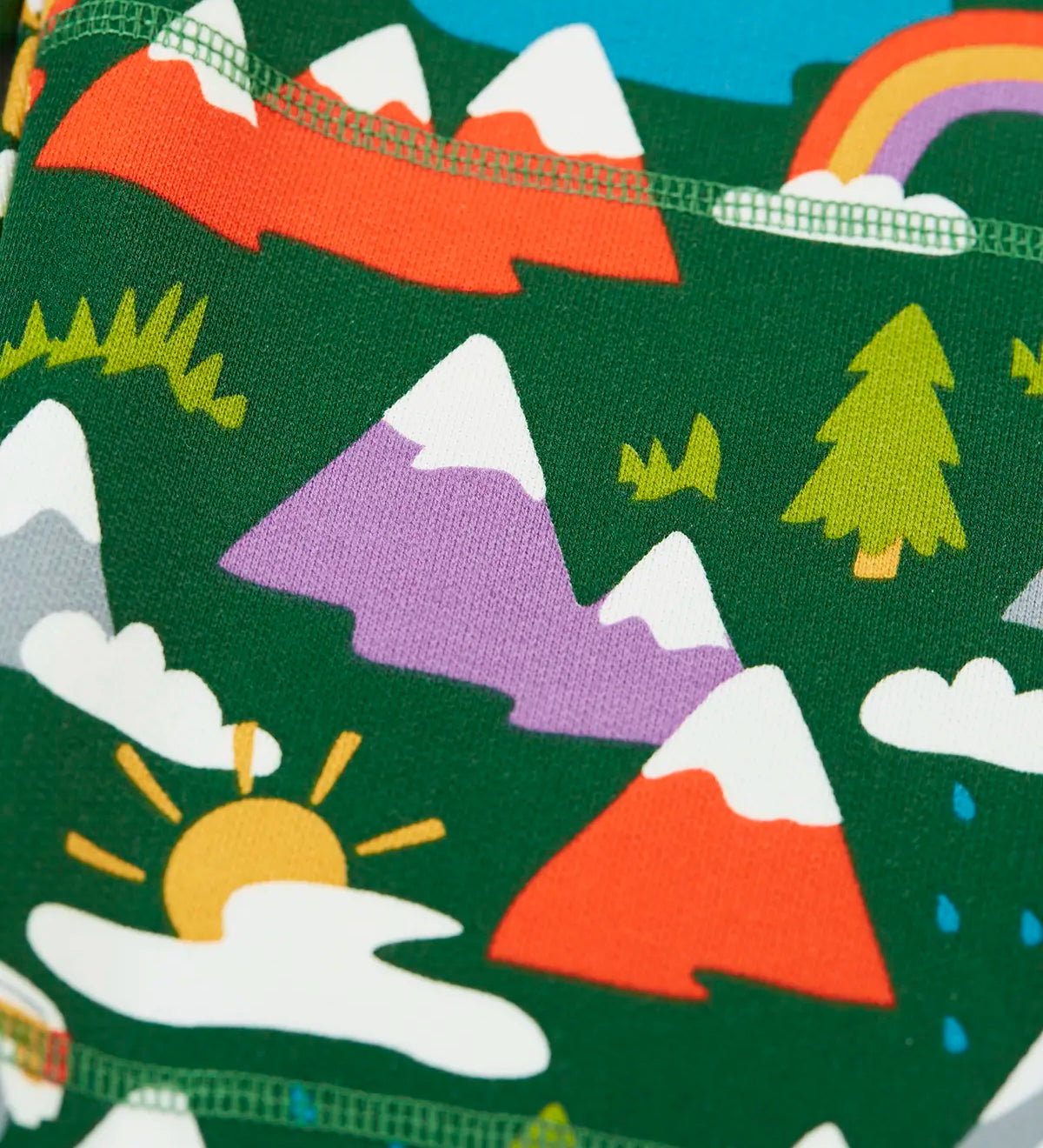 Close up of the colourful mountains featured on the Frugi organic cotton green malpas joggers with rescue trails print. 