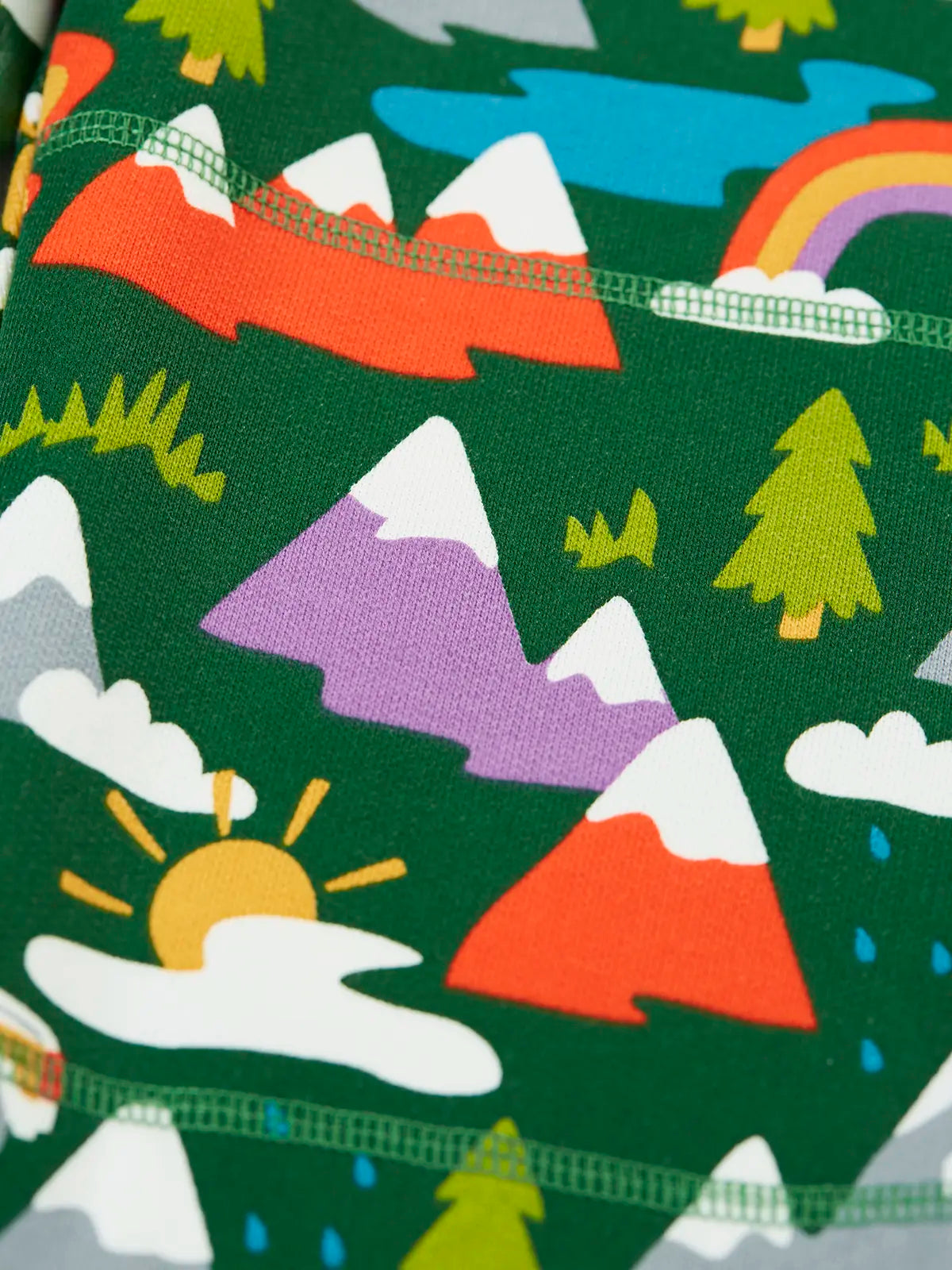 Close up of the colourful mountains featured on the Frugi organic cotton green malpas joggers with rescue trails print. 