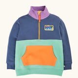 Frugi organic cotton half zip sweatshirt hotchpotch wildlife. Colourblock top with light blue bottom half, navy op and arms, purple collar and orange kangaroo pocket. Rectangle shaped wildlife badge on the chest.