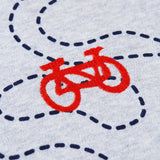 A close up of the red embroidered bicycle detail on the front of the Frugi Compass Organic Cotton Hooded Top.