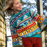 Child wearing a Frugi festive fair isle organic cotton jumper with rust corduroy trousers.
