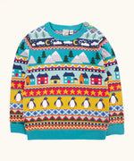 Frugi festive fair isle organic cotton children's jumper. Multicoloured fairisle design featuring penguins, stars, houses, mountain, trees, clouds and snowy clouds.