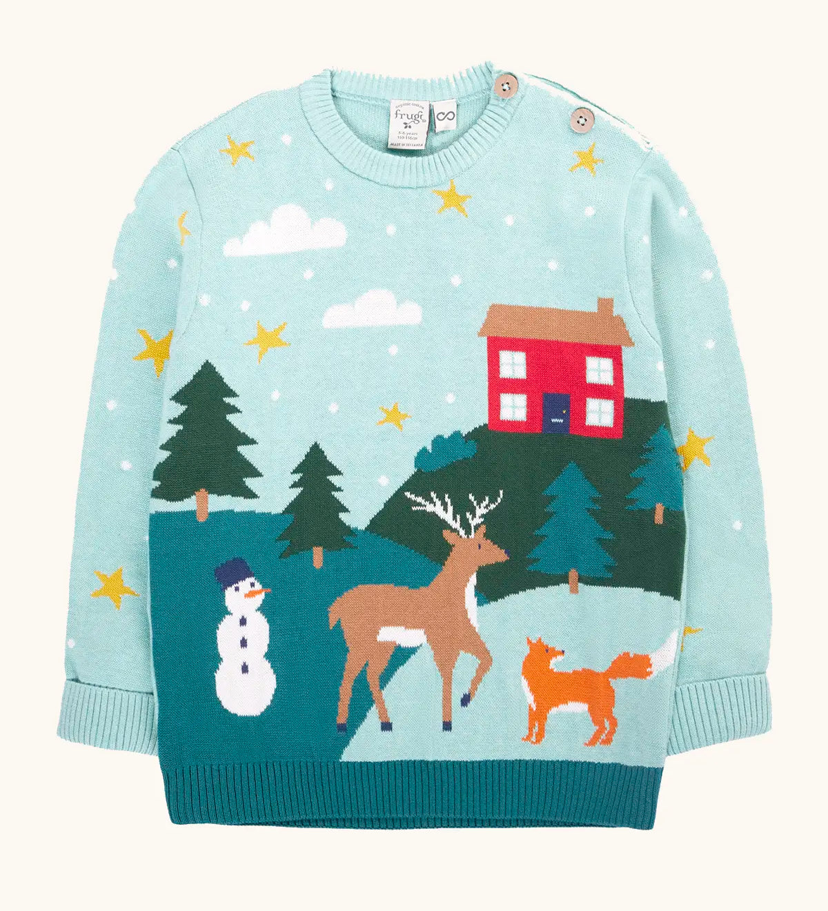 Frugi organic cotton elwood knitted jumper with a Winter tales design. Light blue long sleeved jumper with a landscape design on the front featuring a red house, snowman, reindeer, fox, trees and snow and stars.
