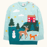 Frugi organic cotton elwood knitted jumper with a Winter tales design. Light blue long sleeved jumper with a landscape design on the front featuring a red house, snowman, reindeer, fox, trees and snow and stars.