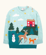 Frugi organic cotton elwood knitted jumper with a Winter tales design. Light blue long sleeved jumper with a landscape design on the front featuring a red house, snowman, reindeer, fox, trees and snow and stars.