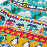 Close up of the patterns on the shoulder of the Frugi festive fair isle organic cotton jumper. Multicoloured fairisle design featuring penguins, stars, houses, mountain, trees, clouds and snowy clouds.